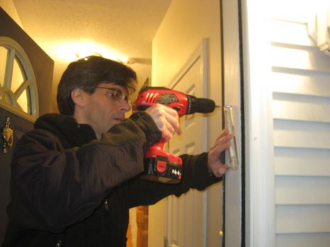 affixing mezuzah to the front door.JPG